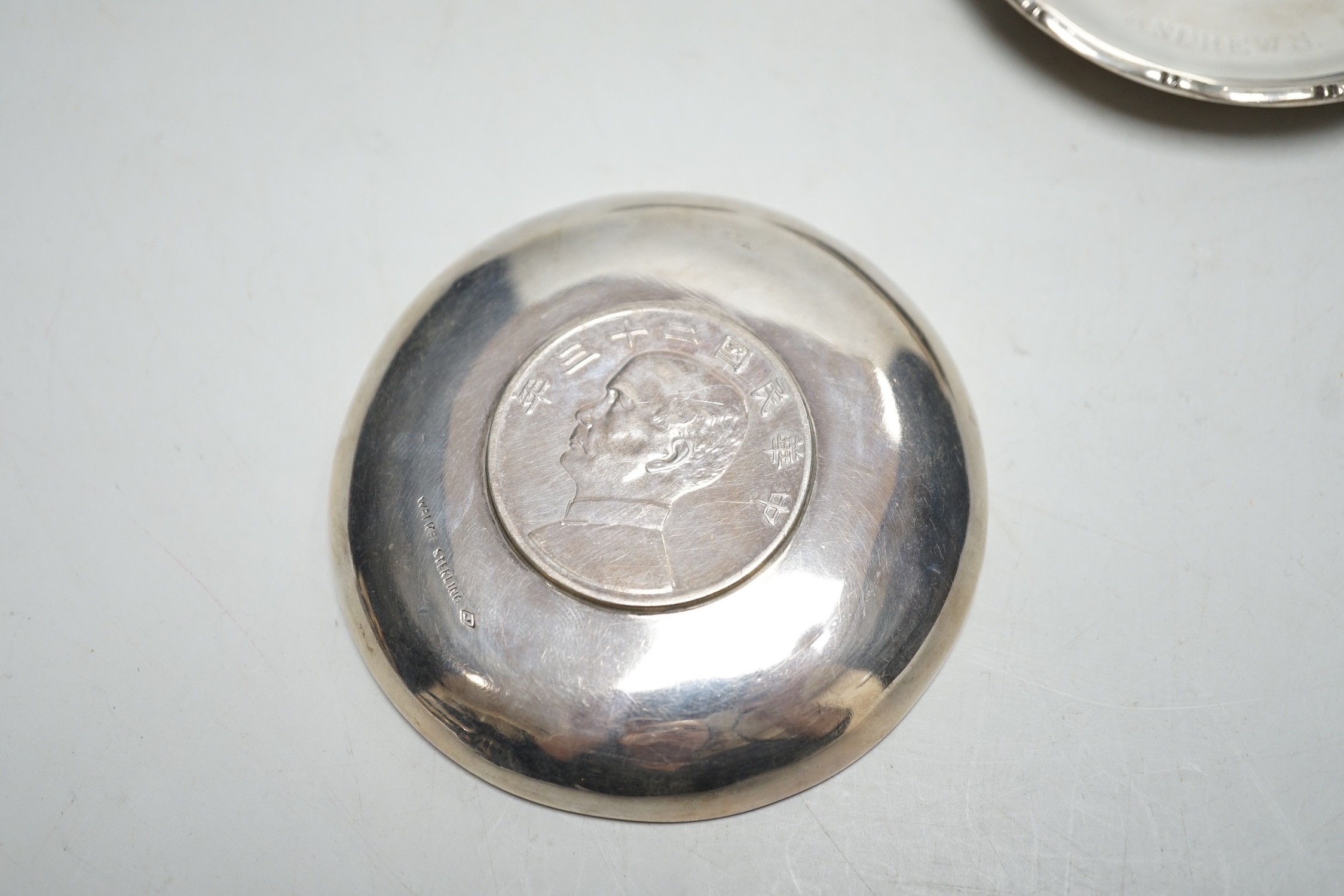 Three Hong Kong white metal mounted Republic of China coin dishes and a similar One Dollar 1930 dish, largest diameter 9cm.